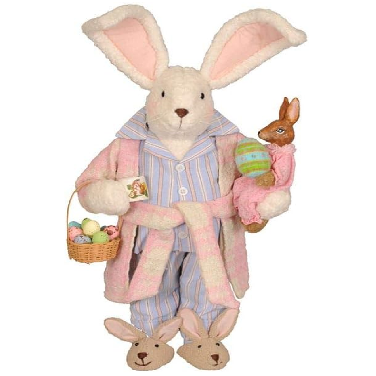 Bunny figurine in pajamas holding a basket of eggs and a baby bunny on a white background