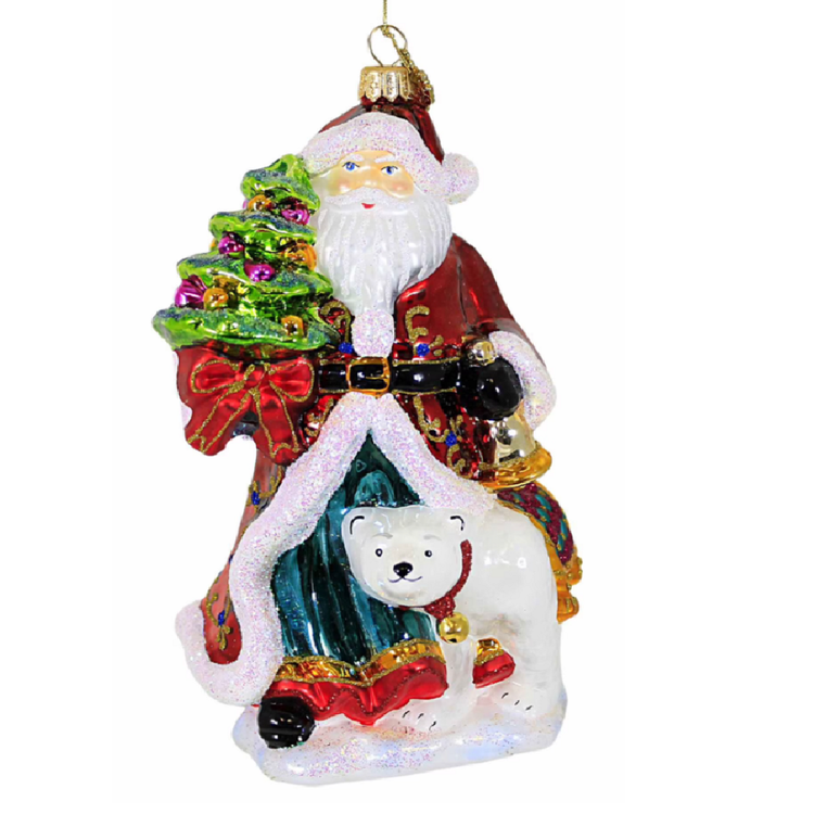 A Santa Claus Christmas ornament featuring Santa in a red coat with white fur trim, carrying a green Christmas tree, with a white polar bear at his feet, shown on a plain white background.