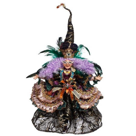 Decorative figurine with intricate costume and feathered headdress on a white background