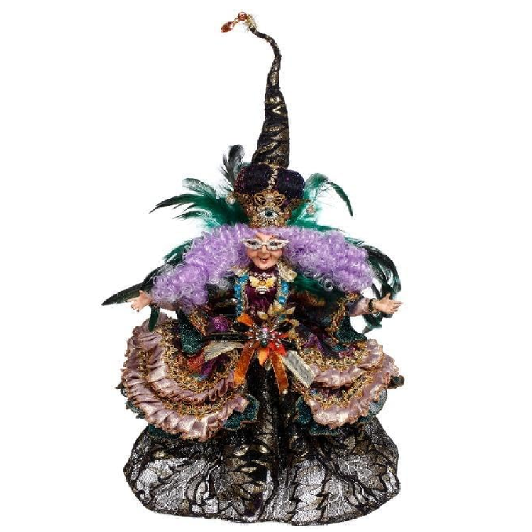 Decorative figurine with intricate costume and feathered headdress on a white background