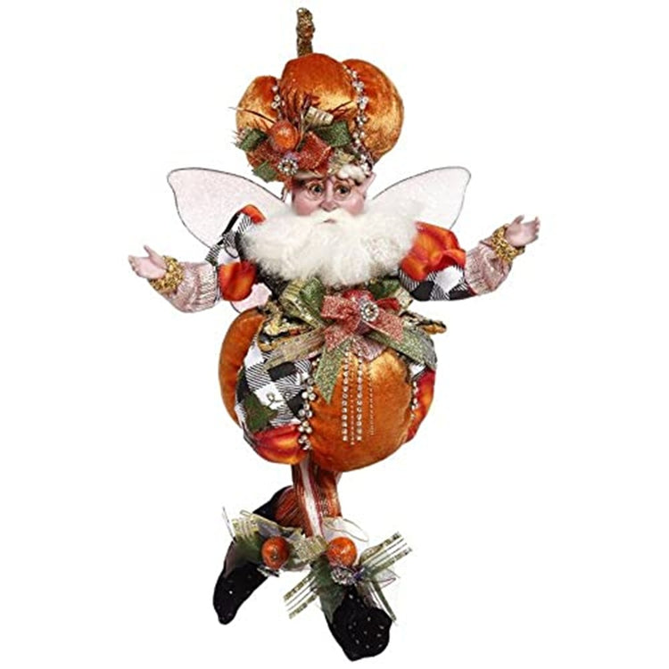 Fairy figurine dressed in a pumpkin outfit with a pumpkin hat. Lots of bows and wearing black booties.