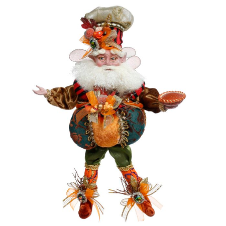 Bearded Fairy dressed in chefs hat and pumpkin outfit, holding a pumpkin pie.