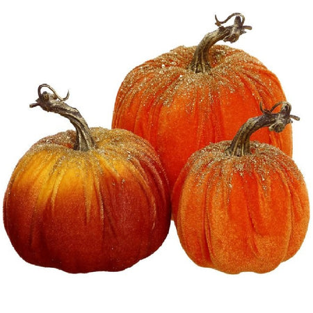 a set of three faux pumpkins in different shades of orange, with gold glitter accents.