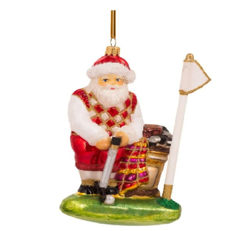Blown glass hanging ornament of Santa in golf clothes on a putting green.