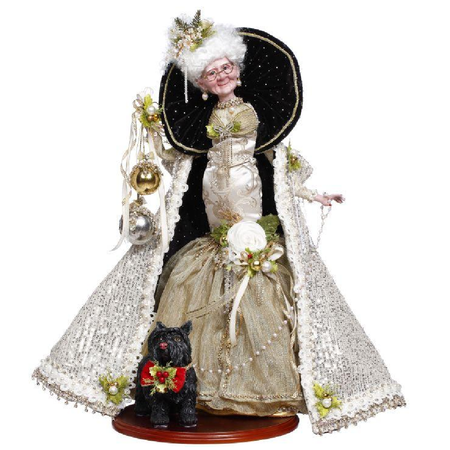 Decorative figure of Mrs. Claus in an elaborate gown with a black dog, on a white background
