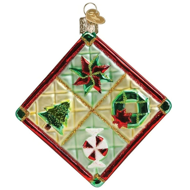 blown glass ornament depicting a christmas themed patchwork quilt.