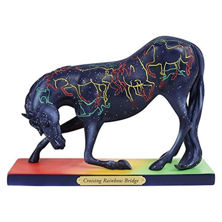 Bowing horse on wood stand with metal plate name 'Crossing Rainbow Bridge". The horse is black with colorful outlines of horses in green, red and yellow with white speckles throughout.