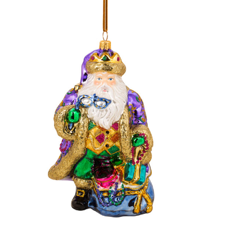 Santa ornament dressed in mardi gras colors and holding a mask.