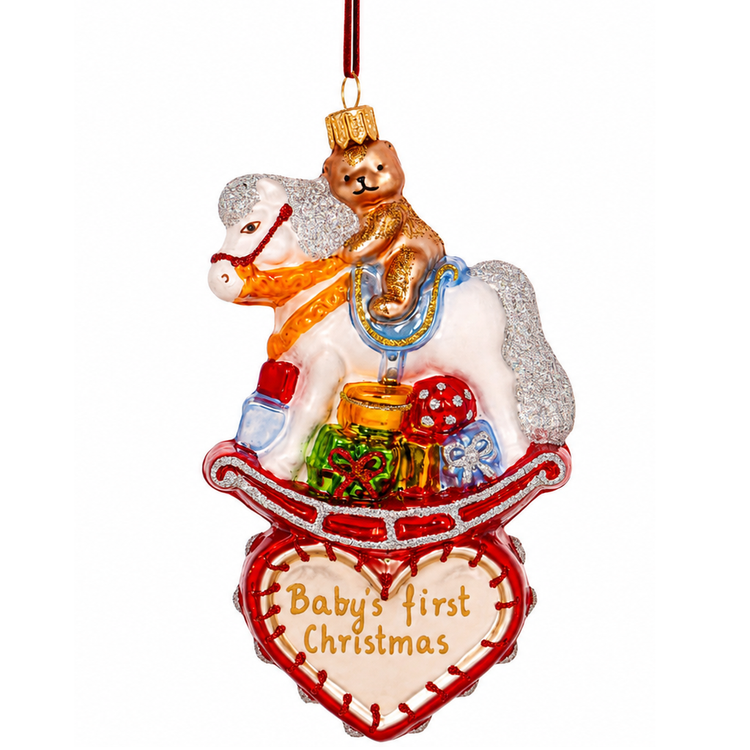 blown glass ornament of a rocking horse above a red heart that says "Baby's First Christmas"