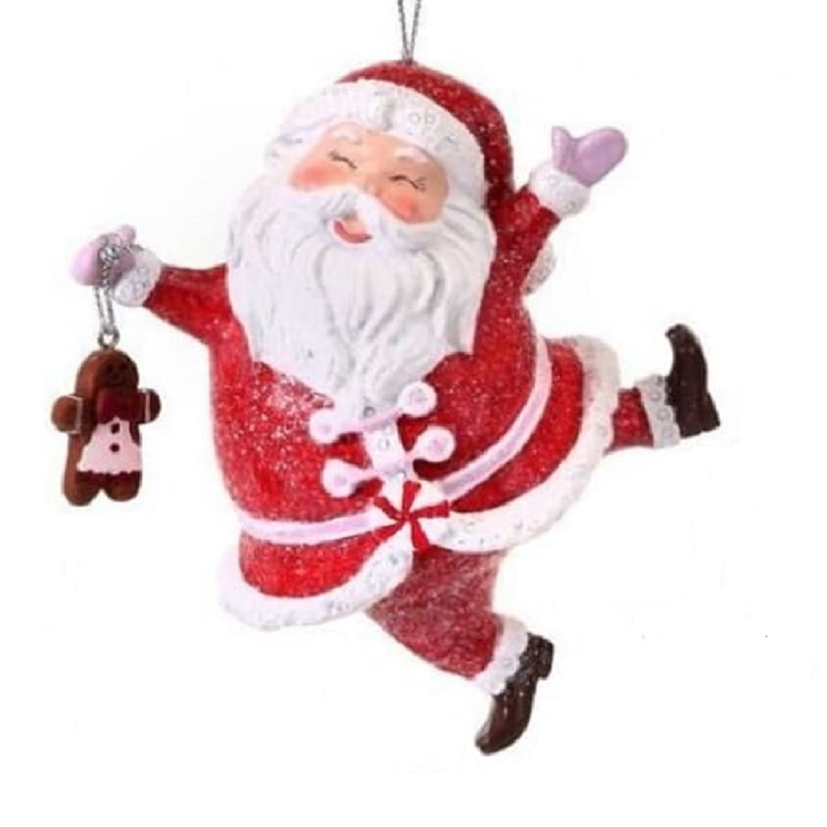 red santa hanging ornament holding a gingerbread man