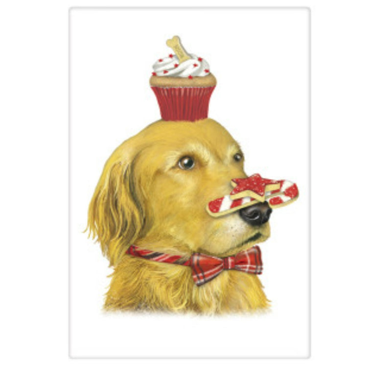 White towel with a picture of a golden retriever dog wearing a red plaid bow with a cupcake on his head and a candy can resting on his nose.