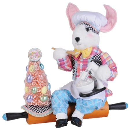 Rabbit figurine with a checkered outfit and hat, sitting on a rolling pin, with an easter tree and a mixer... on a white background.