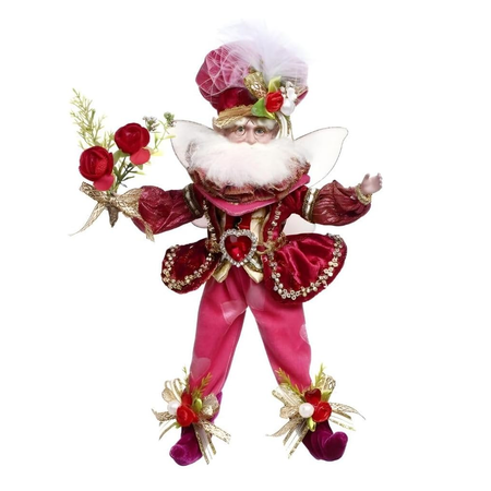 Decorative figure of a fairy in red and pink attire with flowers on a white background