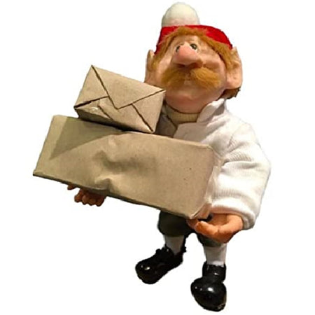 Standing elf figure wearing a white jacket and santa hat. Mustache. Carrying 2 brown packages.