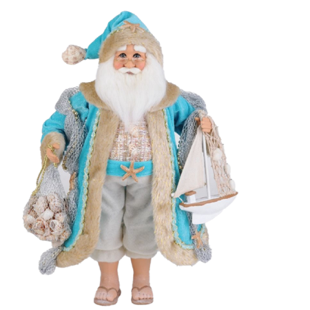 Santa Claus figurine with a teal coat with tan fur trim. He carries a bag of seashells and a model sailboat. Wearing flip flops he is coastal decor