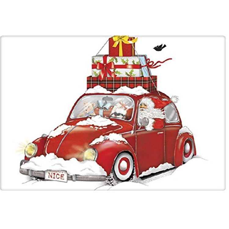 White kitchen towel with Santa driving a red bug car with presents tied to the roof