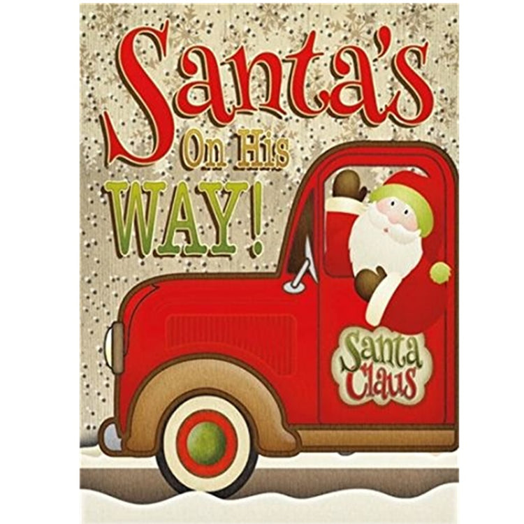 Gold snowflake background on a card with a red pickup truck. Santa is driving. Truck says Santa Claus on drivers door. Santa's On His WAY!