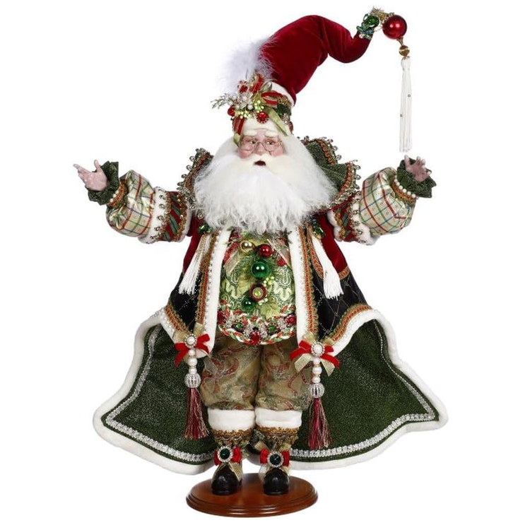 Decorative figure of a Santa Claus in festive attire on a white background