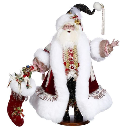 Decorative figure of a traditional Santa Claus holding a stocking on a white background