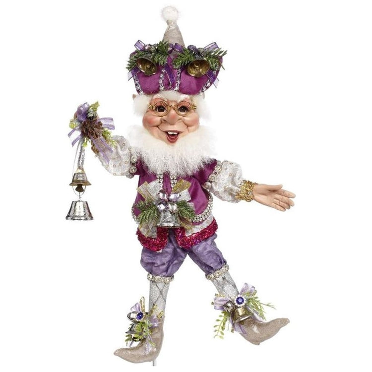bearded fairy in purple outfit and hat, adorned with bells, he's holding a silver bell in his hands.