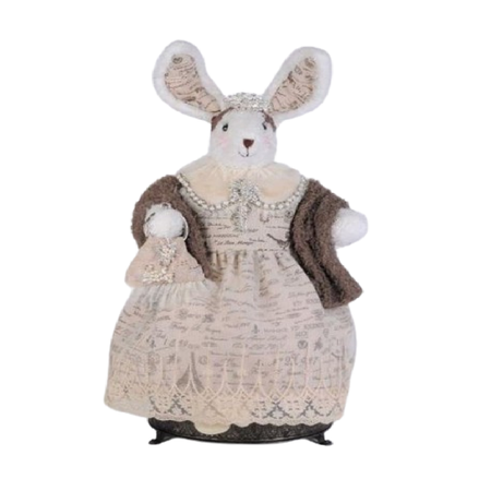 bunny figurine wearing light pink paris patterned dress and a light brown shawl.