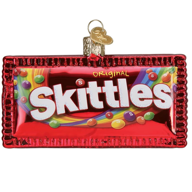 Blown glass ornament that is shaped like a skittles packet. Has original skittles red logo.
