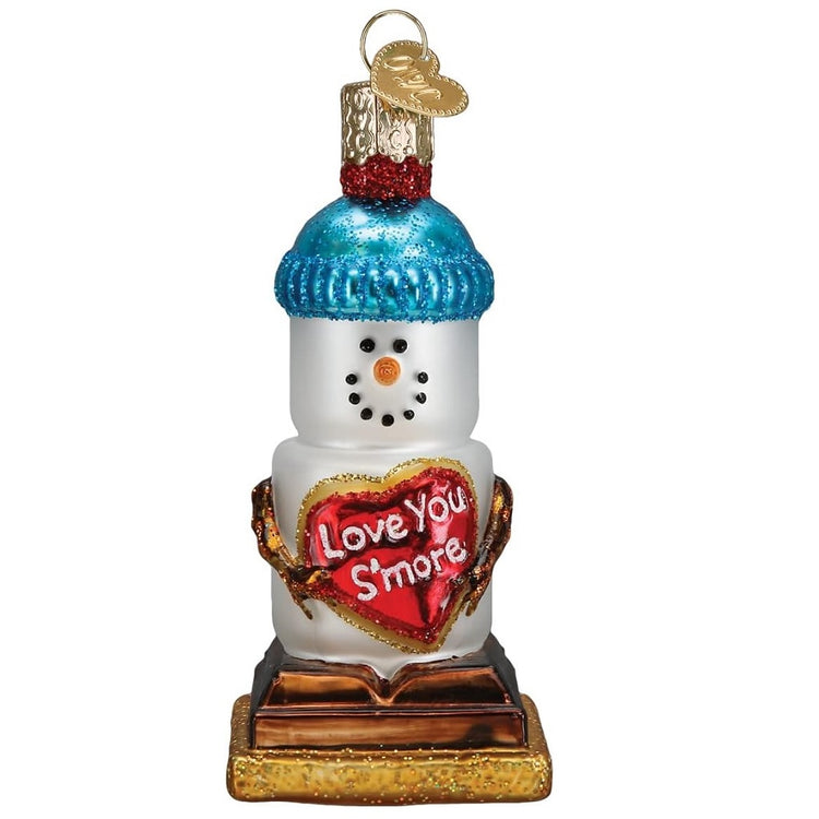 Blown glass hanging ornament, depicting a snowman made of marshmallows, sitting on chocolate and a graham cracker. he's holding a heart that says "love you s'more"