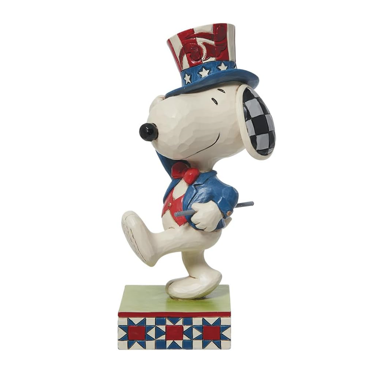 Snoopy figurine wearing a patriotic hat and outfit on a white background