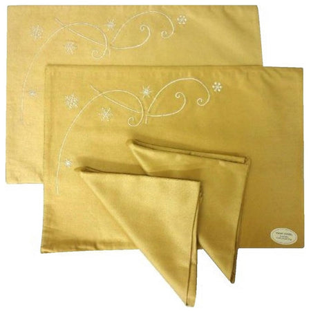 2 gold fabric placemats with white embroidered snowflakes, and 2 matching napkins.