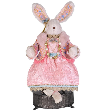 Decorative rabbit figure in a pink dress with jewelry on a white background
