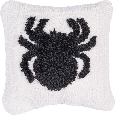 Decorative pillow with a black spider design on a white background