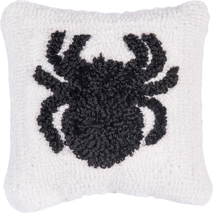 Decorative pillow with a black spider design on a white background