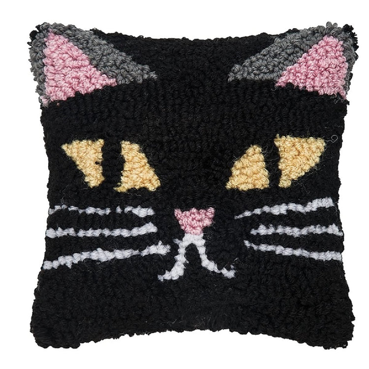 hooked rug style pillow in black with a spooky cats face on it.