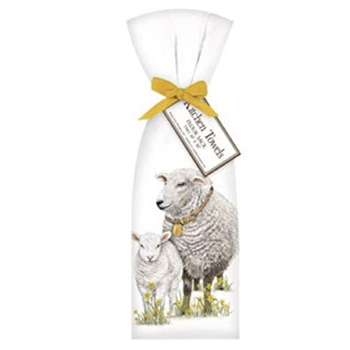 White towel with gold ribbon. Mom and baby sheep standing in yellow flowers.