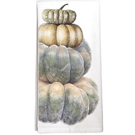 folded white kitchen towel with 4 pumpkins stacked on top of eatch other.  Shades of almost blue and orange.