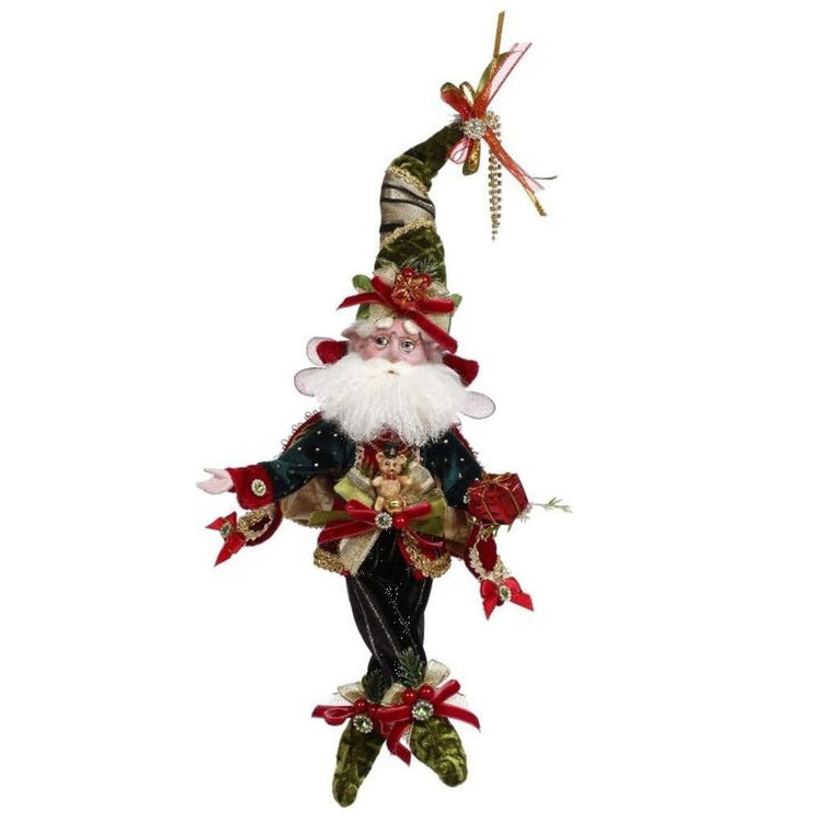 bearded fairy wearing dark green and gold outfit with matching stocking cap. adorned with red bows, a teddy bear figure, and small wrapped gifts.