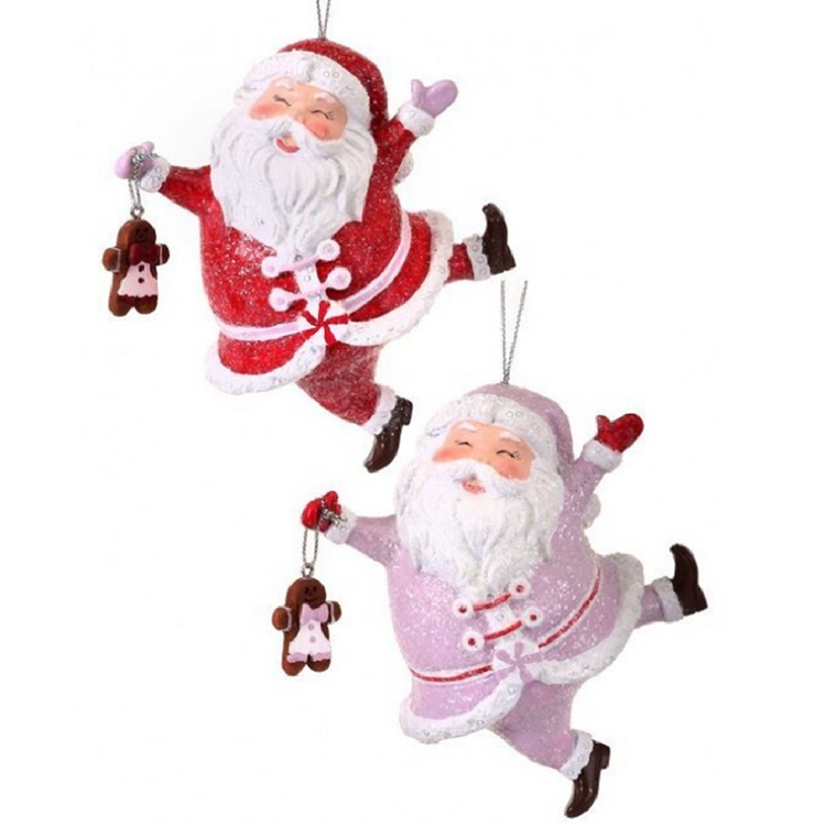 2 santa ornaments, one is pink and one is red. Both have a sparkle finish and are holding  agingerbread man