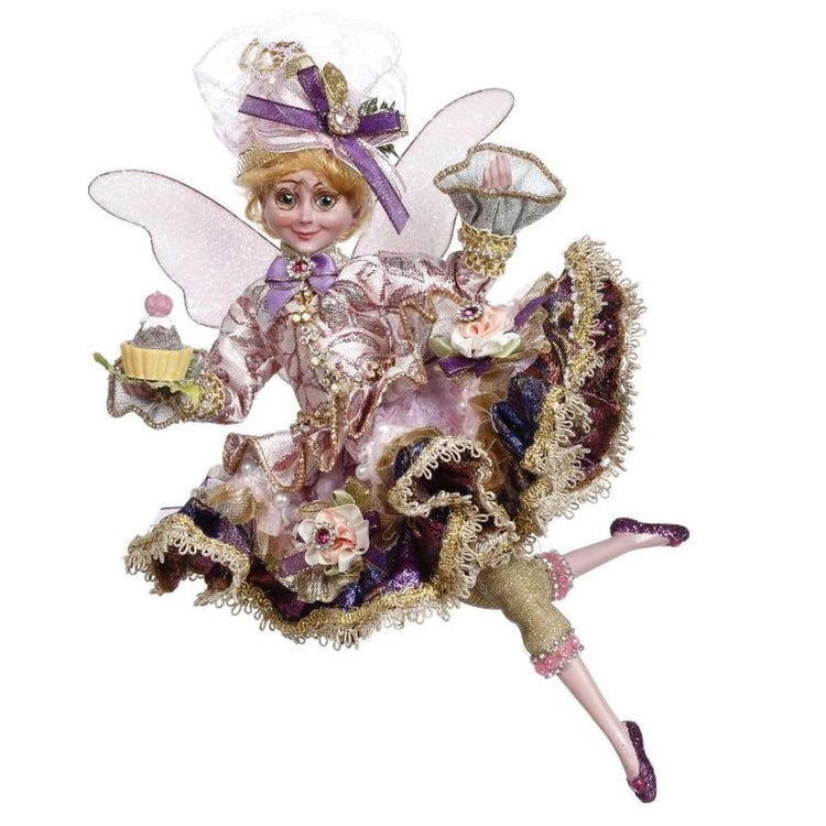 girl fairy in pink and purple ruffled dress, holding a dessert in one hand.