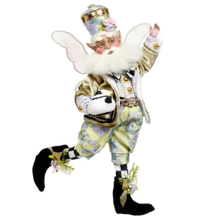 bearded fairy in gold jacket and floral pants. He's holding a teapot.