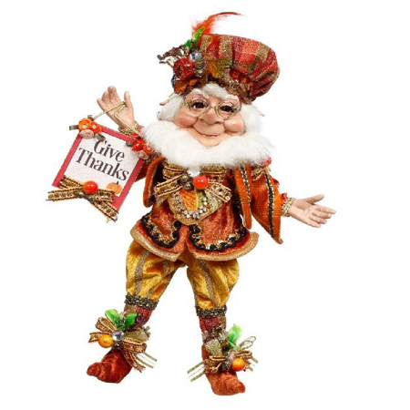 Decorative figure of an elf holding a 'Give Thanks' sign on a white background