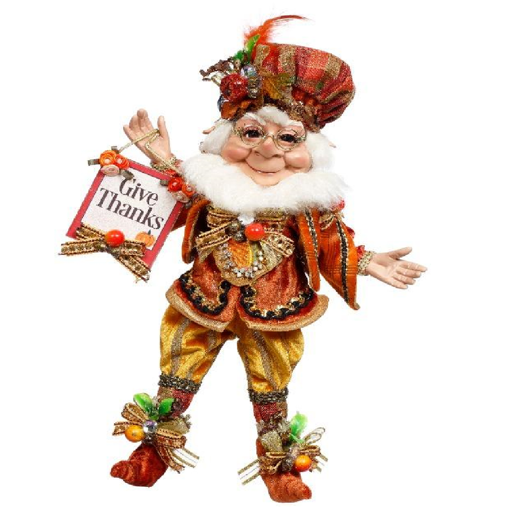 Decorative figure of an elf holding a 'Give Thanks' sign on a white background