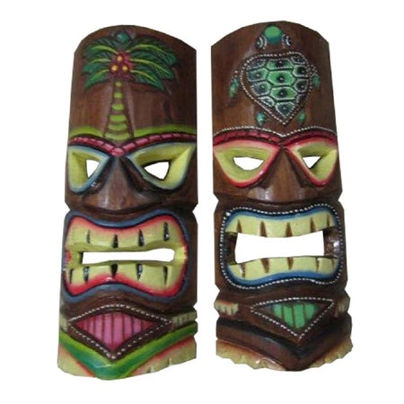 2 tiki masks. Both cared from wood with large mouths and teeth.  Painted in shades of green, yellow and red on wood stain mask.  One has a palm tree decoration on the top and one has a sesa turtle