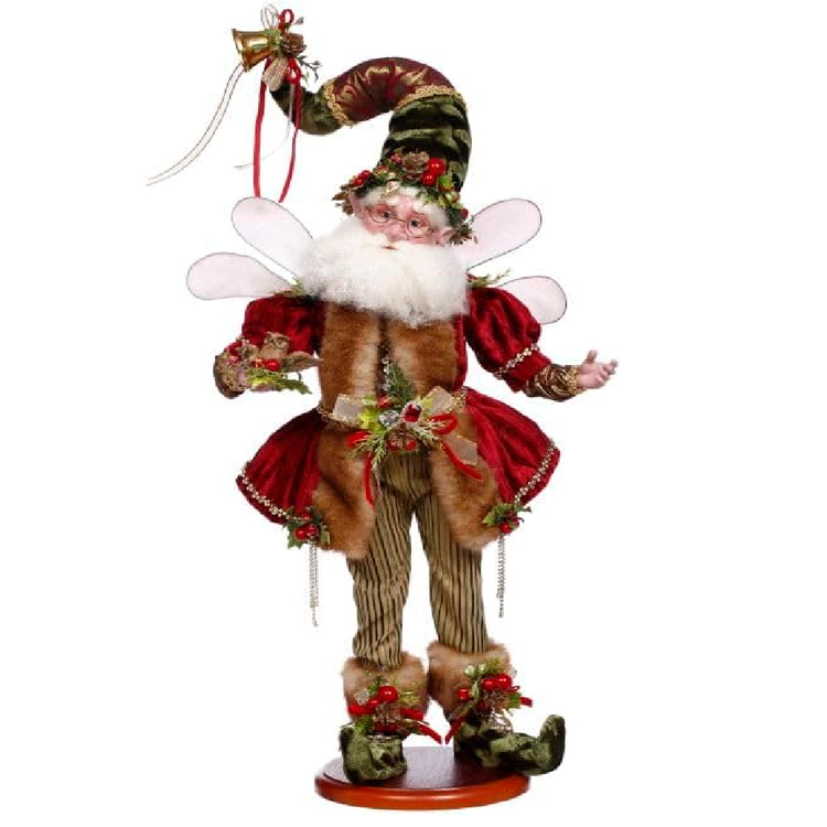 Bearded fairy wearing red coat with fur lining and berry and pinecone accents.