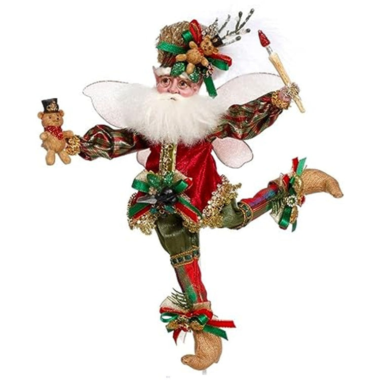fairy waring green pants with red an dgreen ocks and gold booties. He holds a teddy bear in one hand and a paintbrush in the other.  Hat has a bow and teddy bear adorned on it.