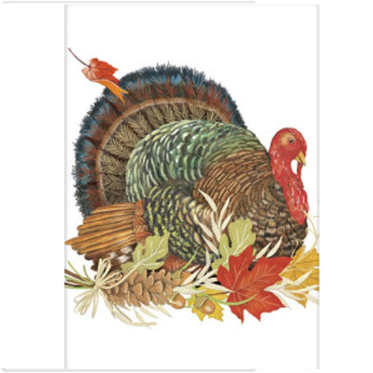 White kitchen towel with turkey with fall leaves in front of it.