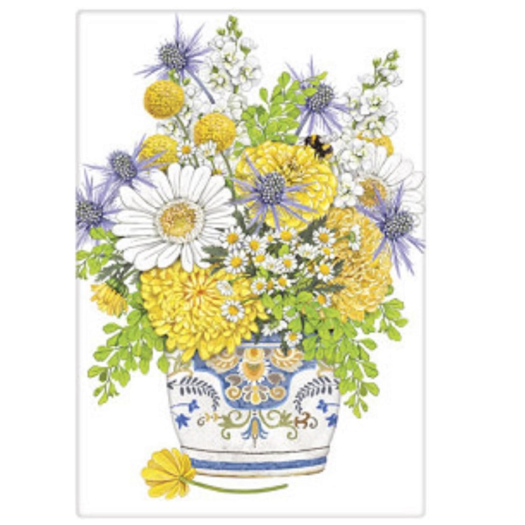 Floral arrangement with yellow and blue flowers in a decorative pot on a white background