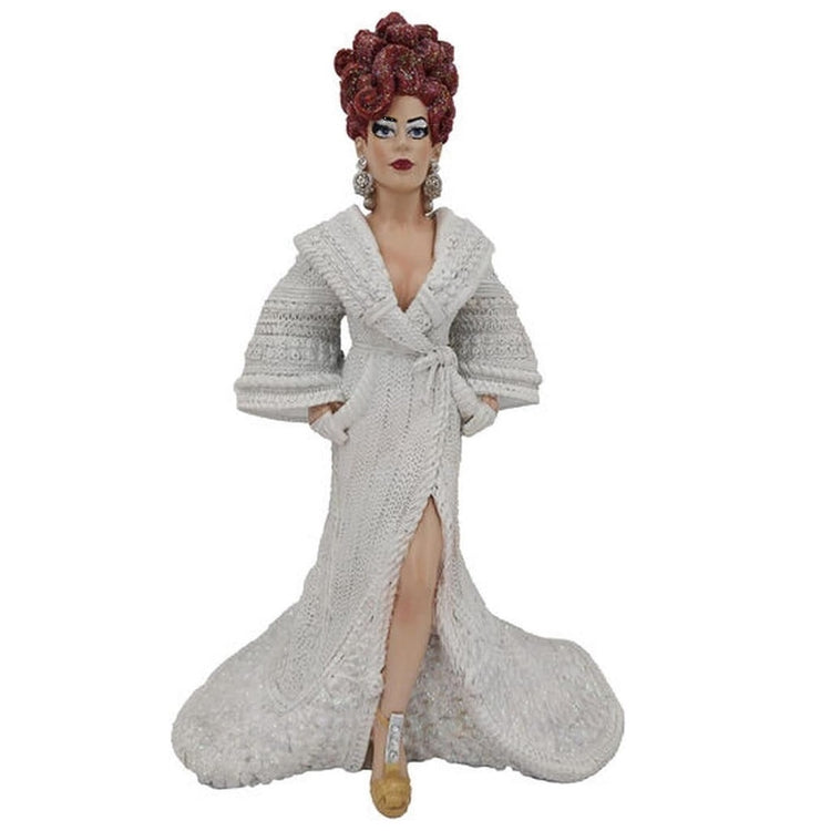 Drag queen ornament with red curly hair and a white crochet robe