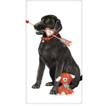 white kitchen towel with a black lab holding a cupids bow in his mouth with a red teddy bear at his feet.