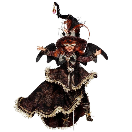 orange curly haired witch with bat wings, black velvety dress with gold fringe.