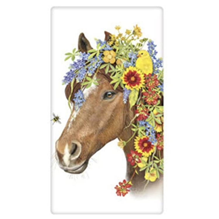 white kitchen towel with a horse head. The horse has flowers all over his head in yellow and purple. Yellow bird sits in the flowers and a bee is by his nose.